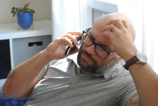 a man with glasses and a watch